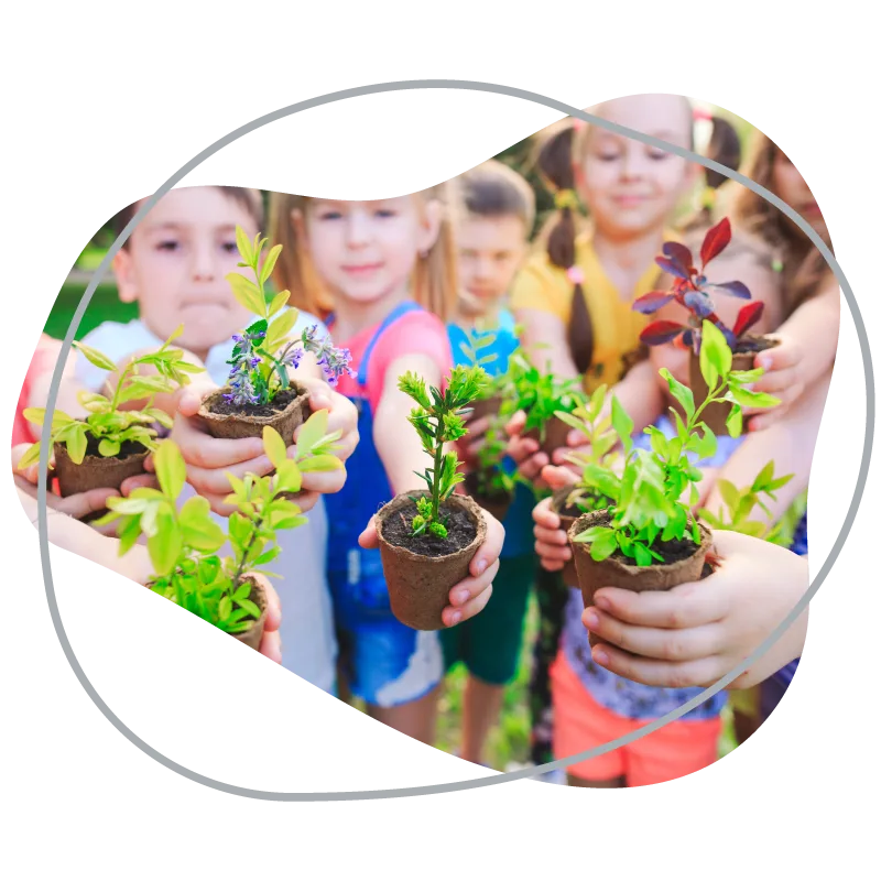 Children holding seedlings they planted